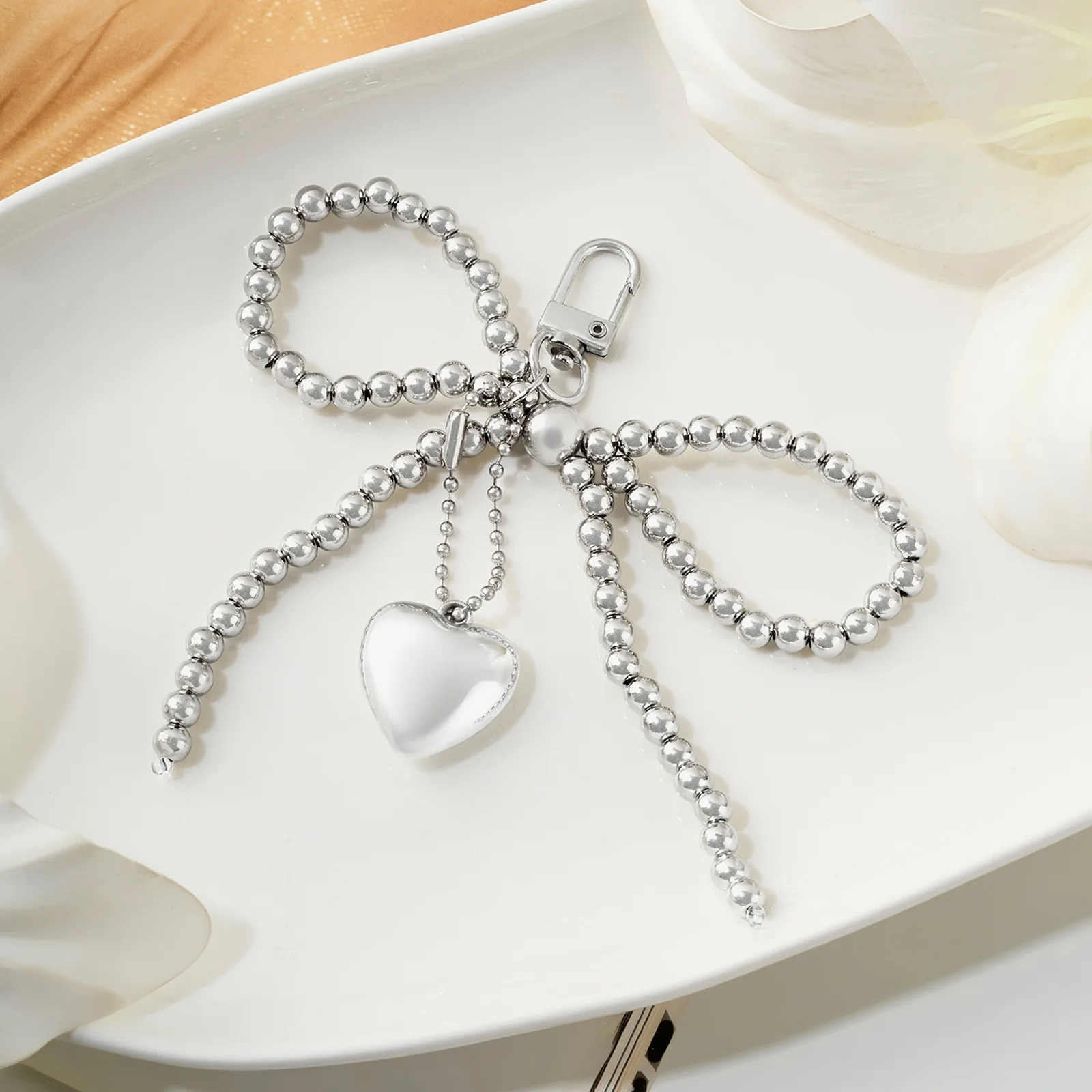 A Bow-Crush Silver Bag Charm